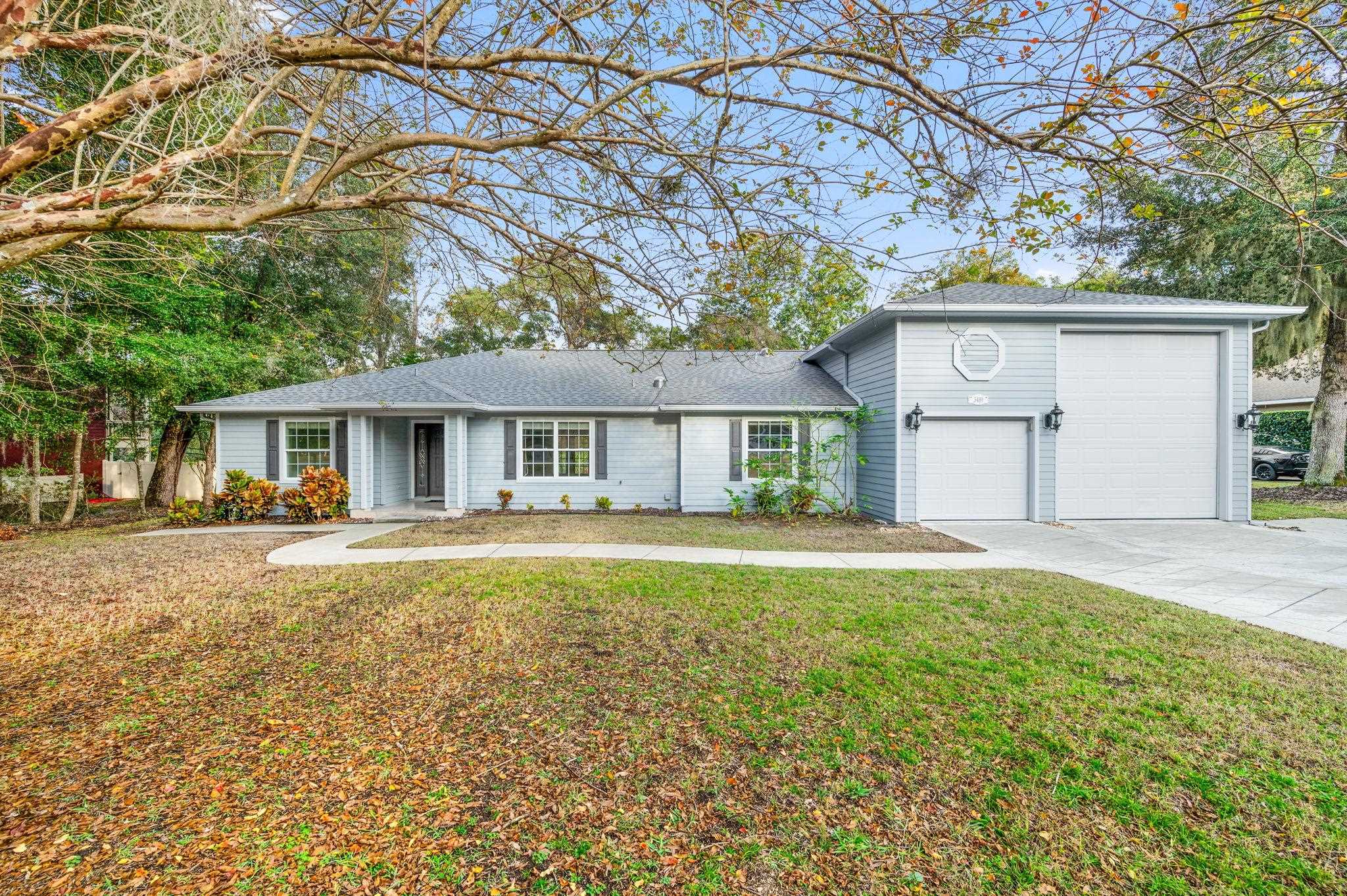 3489 Kings Road St. Augustine, FL 32086 - Photo 2 of 76 a front view of house with yard and trees in the background