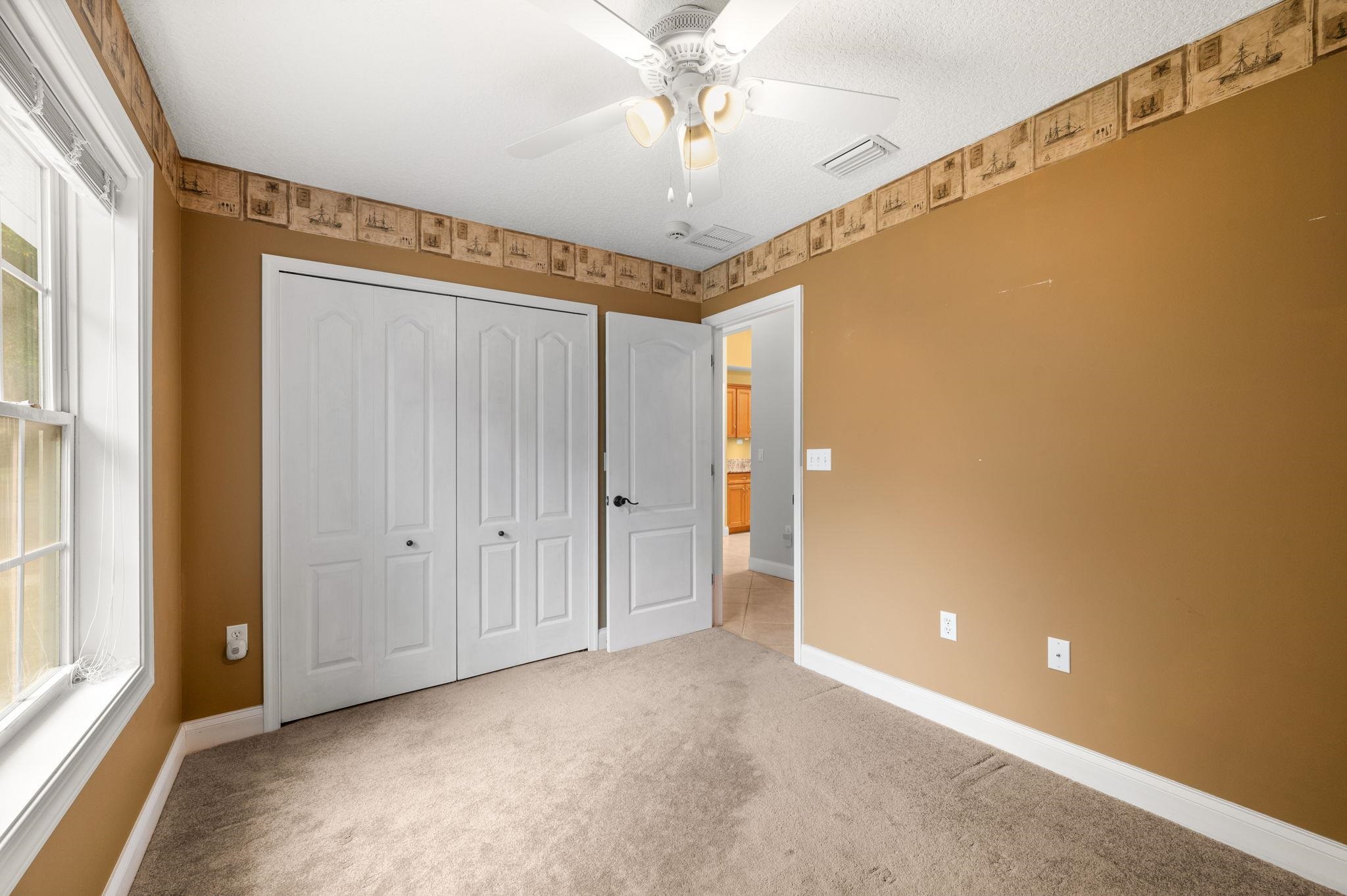 3489 Kings Road St. Augustine, FL 32086 - Photo 28 of 76 a view of a hallway with a chandelier