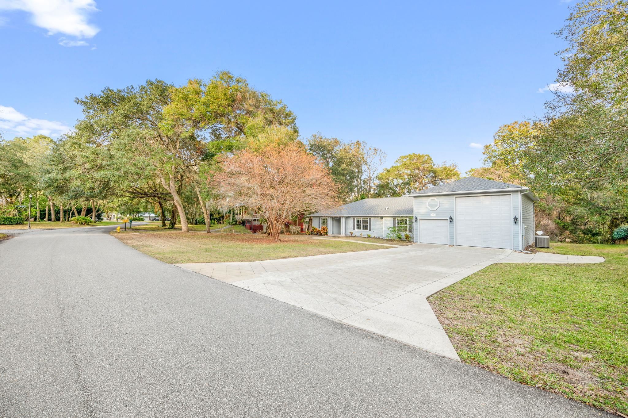3489 Kings Road St. Augustine, FL 32086 - Photo 3 of 76 a view of big house with a big yard and large trees
