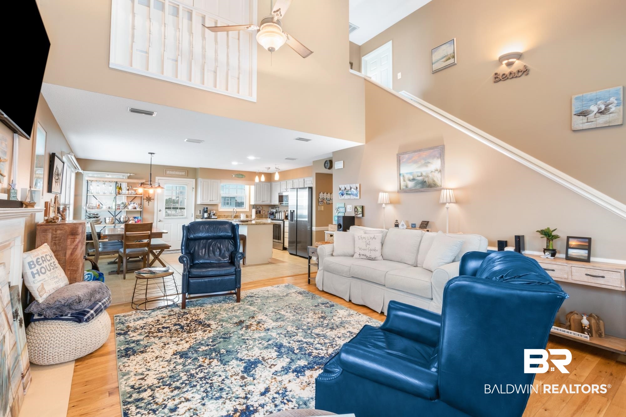 328 Windmill Ridge Road Gulf Shores, AL 36542 - Photo 6 of 47 Living room with ceiling fan, a towering ceiling, and light hardwood / wood-style floors