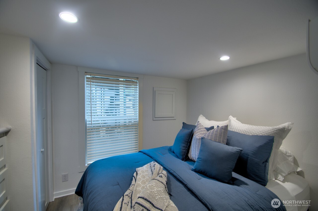 1546 Reservation Road Southeast, Unit 232 Olympia, WA 98513 - Photo 15 of 37 a bedroom with a bed and a couch