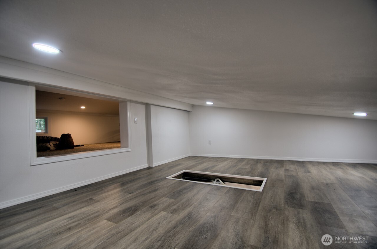 1546 Reservation Road Southeast, Unit 232 Olympia, WA 98513 - Photo 18 of 37 an empty room with wooden floor and windows