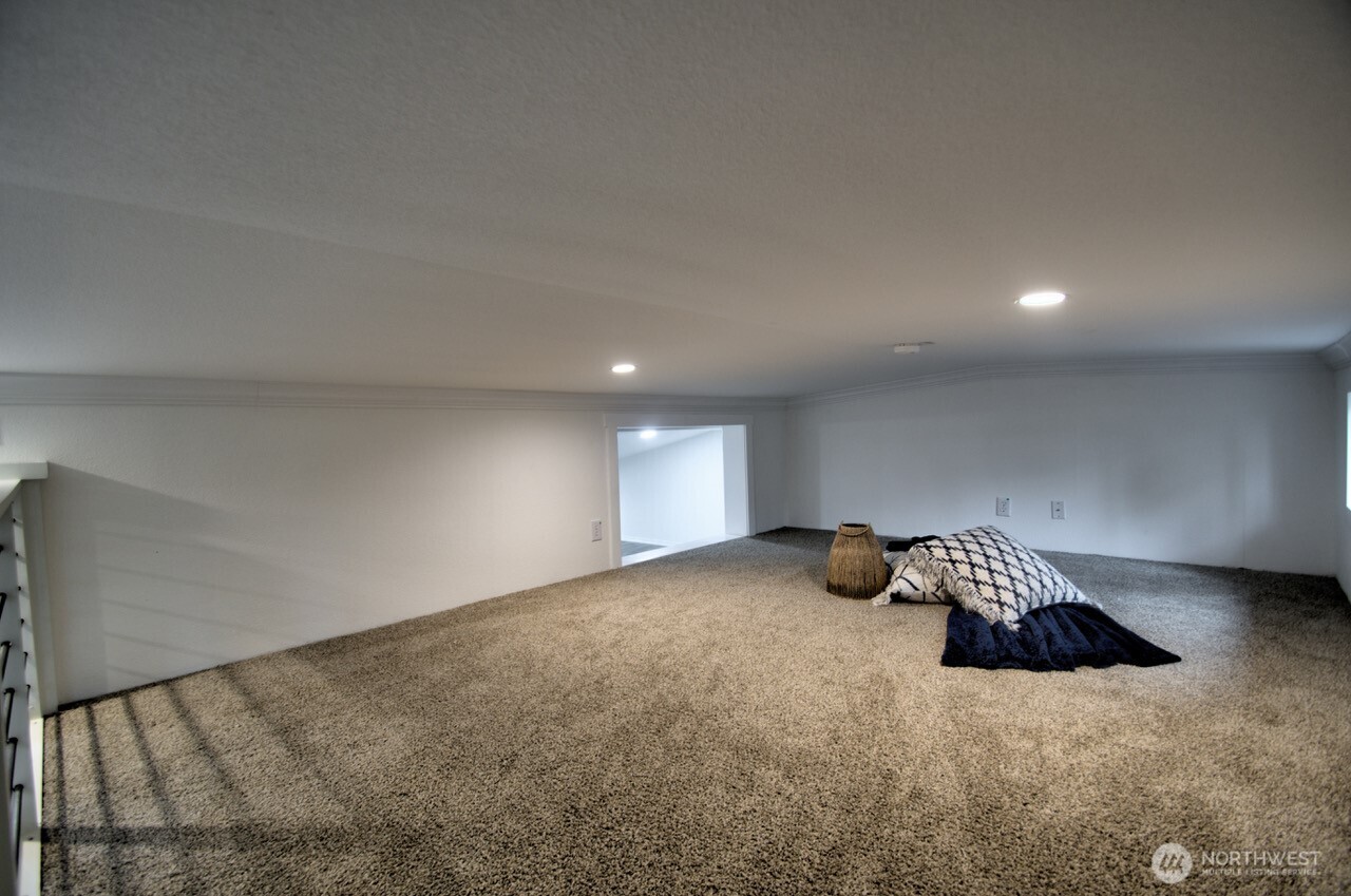 1546 Reservation Road Southeast, Unit 232 Olympia, WA 98513 - Photo 20 of 37 a view of an empty room and wooden floor