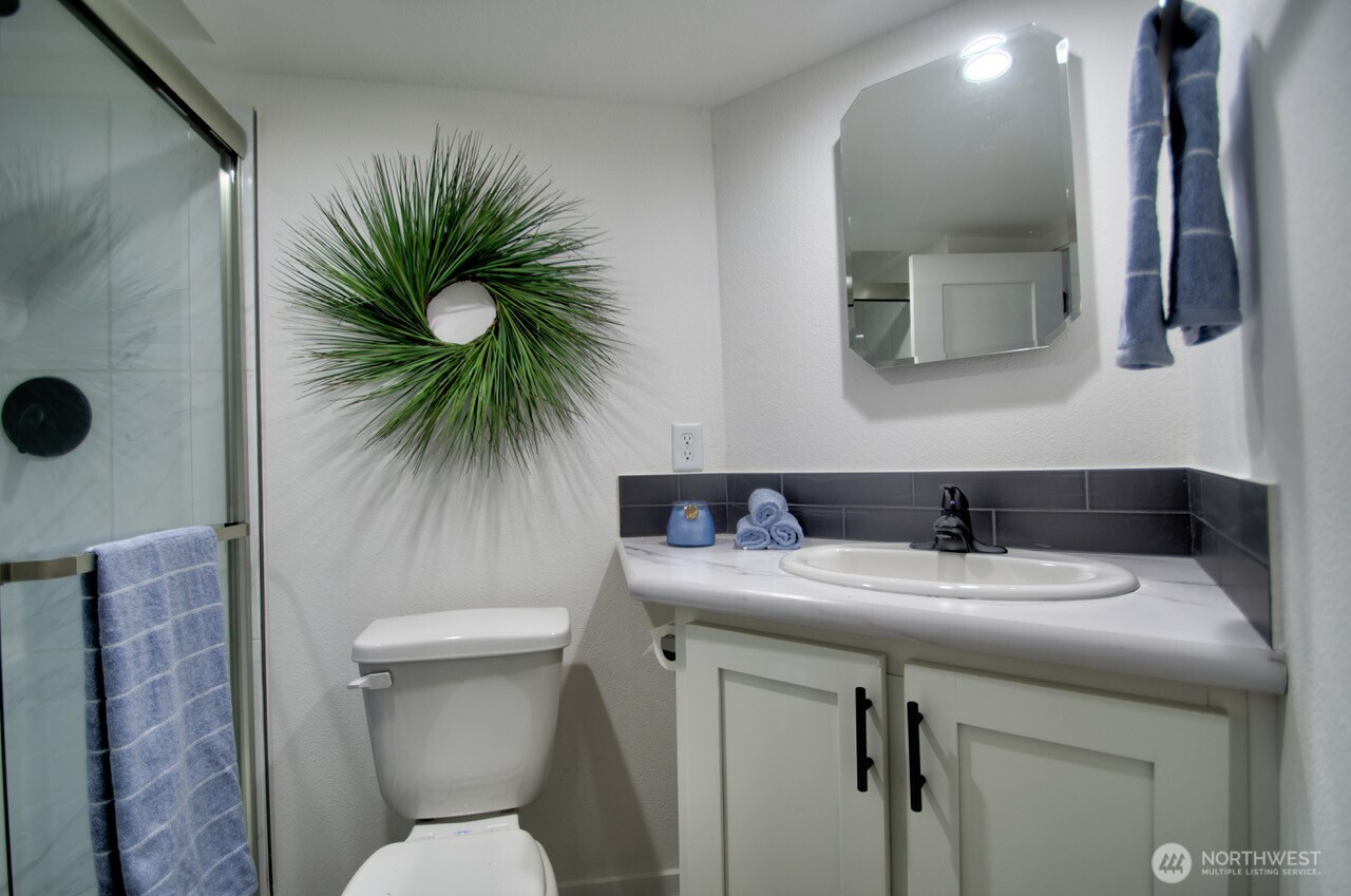 1546 Reservation Road Southeast, Unit 232 Olympia, WA 98513 - Photo 24 of 37 a bathroom with a toilet sink and mirror
