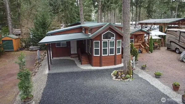 a view of a house with a yard and trees