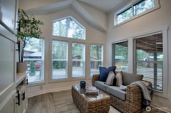 a living room with furniture and large windows