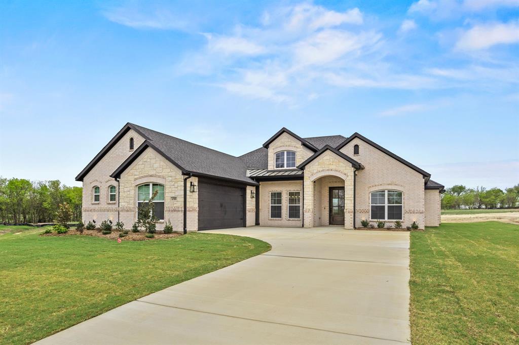 6709 Odom Road Sanger, TX 76266 - Photo 1 of 26 a front view of a house with a yard and trees