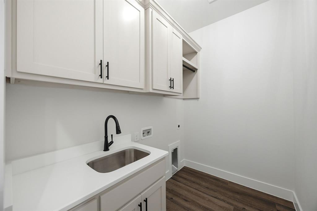 6709 Odom Road Sanger, TX 76266 - Photo 14 of 26 a bathroom with a sink and cabinets