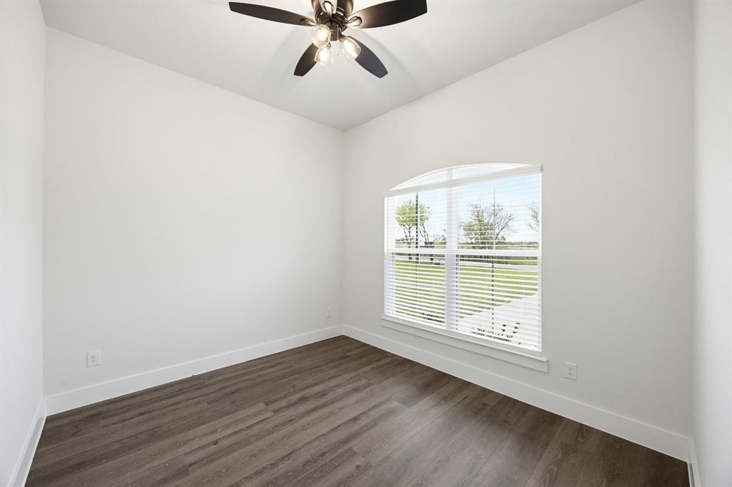 6709 Odom Road Sanger, TX 76266 - Photo 16 of 26 a view of a room with wooden floor and windows