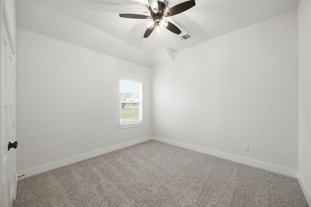6709 Odom Road Sanger, TX 76266 - Photo 18 of 26 an empty room with a window and a fan