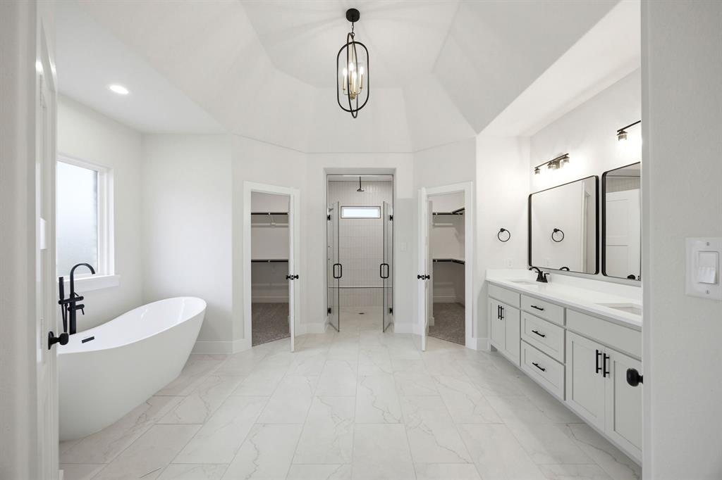 6709 Odom Road Sanger, TX 76266 - Photo 19 of 26 a bathroom with a double vanity sink double mirror and a bathtub
