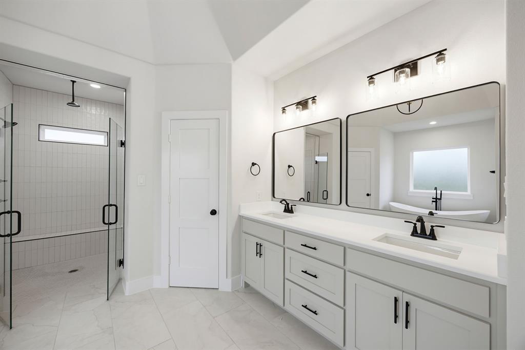 6709 Odom Road Sanger, TX 76266 - Photo 20 of 26 a bathroom with a double vanity sink mirror and