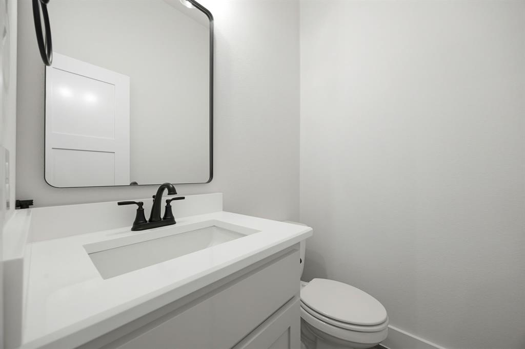 6709 Odom Road Sanger, TX 76266 - Photo 24 of 26 a bathroom with a sink a toilet and mirror