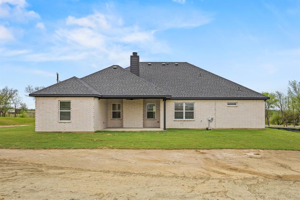 6709 Odom Road Sanger, TX 76266 - Photo 25 of 26 a front view of a house with a yard and garage