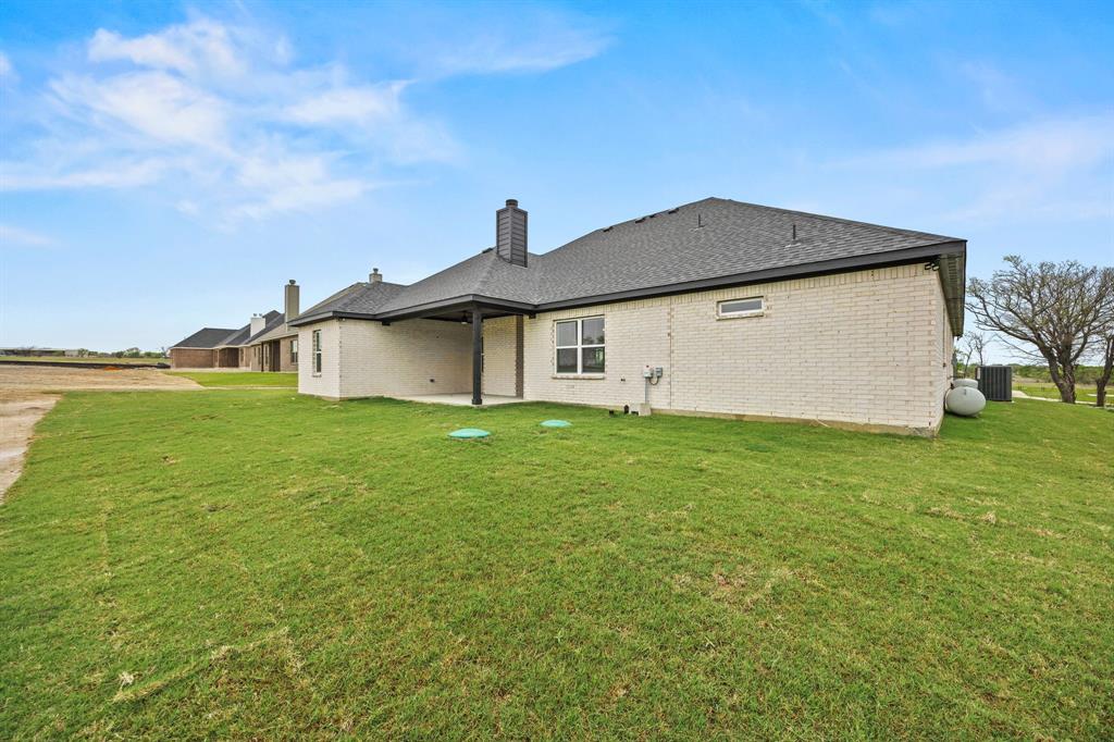 6709 Odom Road Sanger, TX 76266 - Photo 26 of 26 a front view of a house with garden