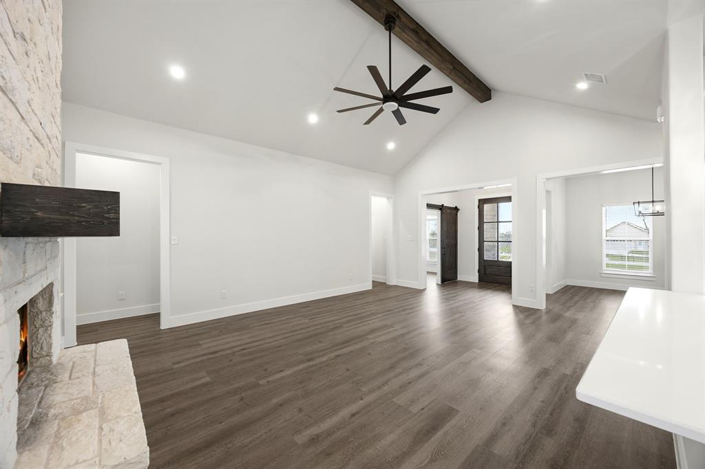 6709 Odom Road Sanger, TX 76266 - Photo 4 of 26 a view of an empty room with wooden floor and a fireplace