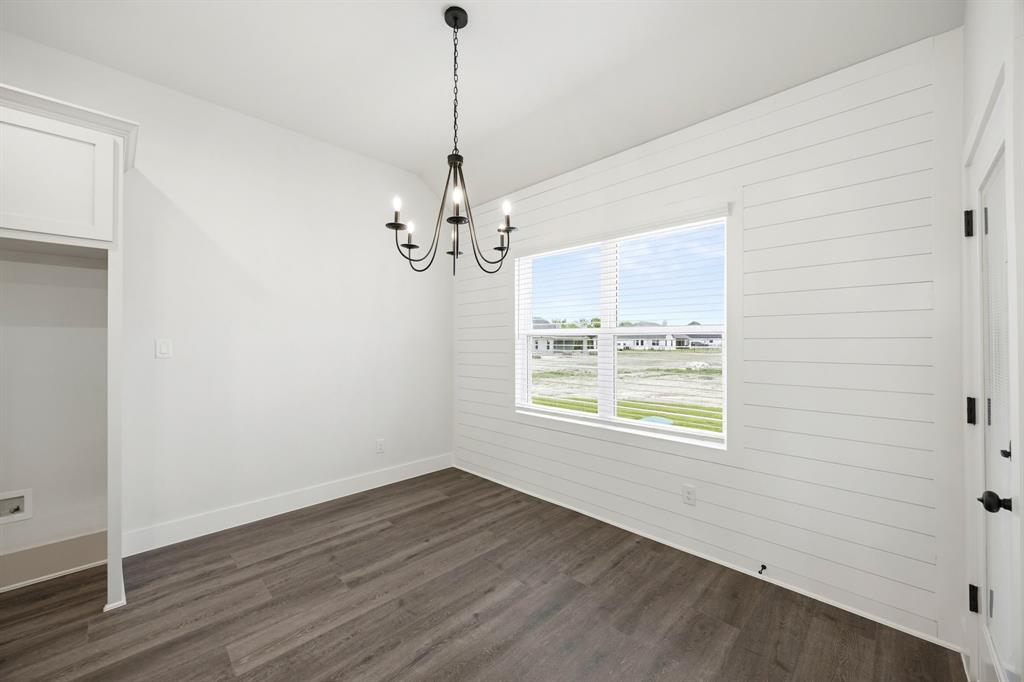 6709 Odom Road Sanger, TX 76266 - Photo 6 of 26 a view of an empty room with wooden floor and a window