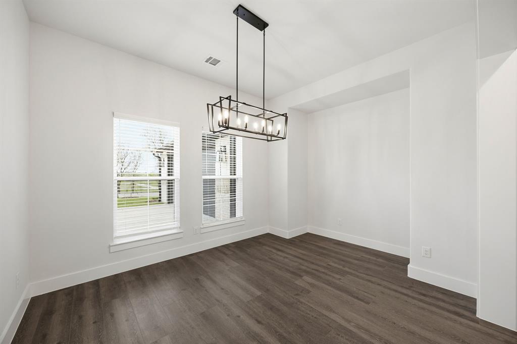 6709 Odom Road Sanger, TX 76266 - Photo 8 of 26 a view of an empty room with wooden floor fridge and a window