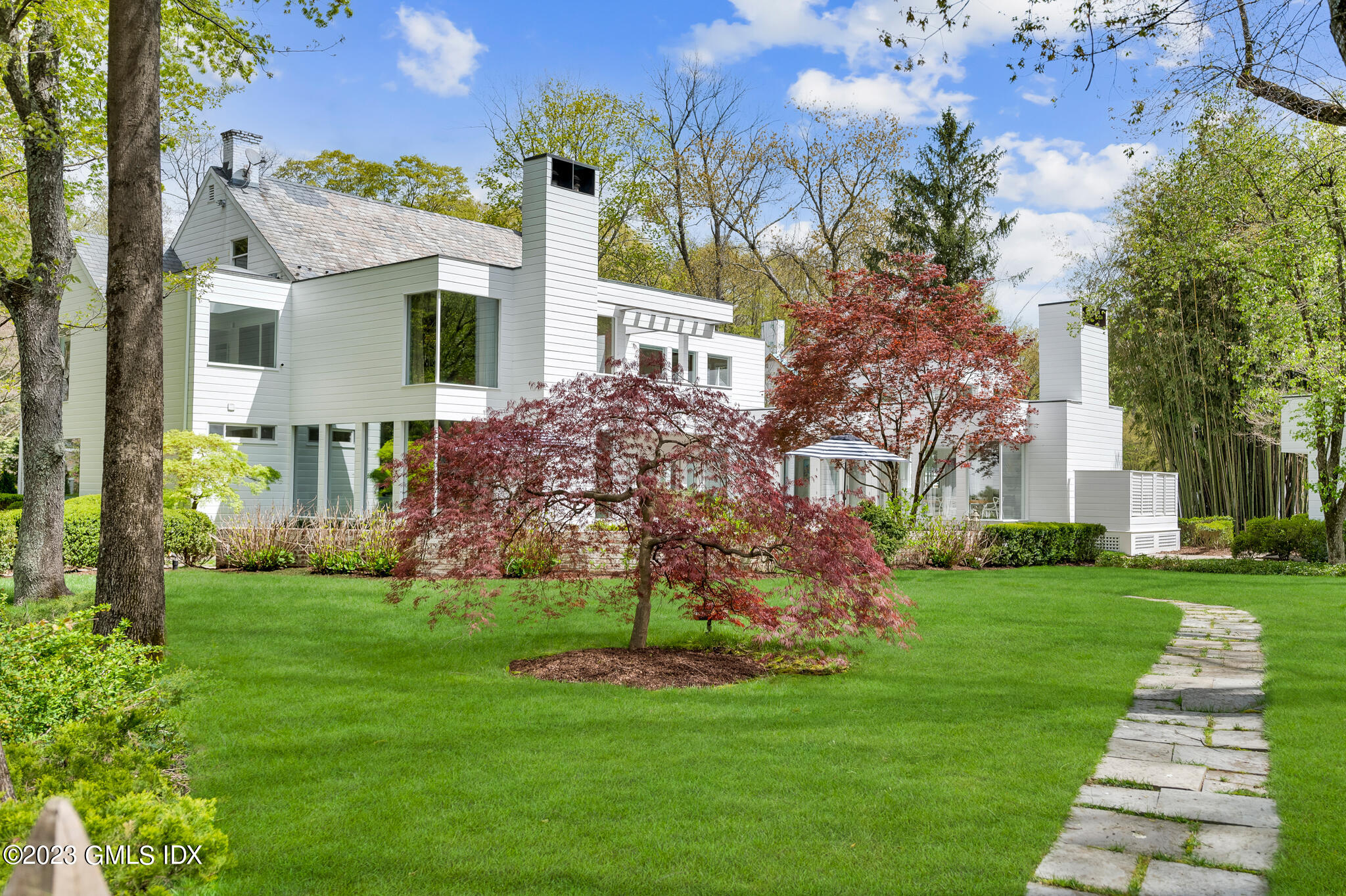 294 Riversville Road Greenwich, CT 06831 - Photo 16 of 17 a view of a front of house with a yard