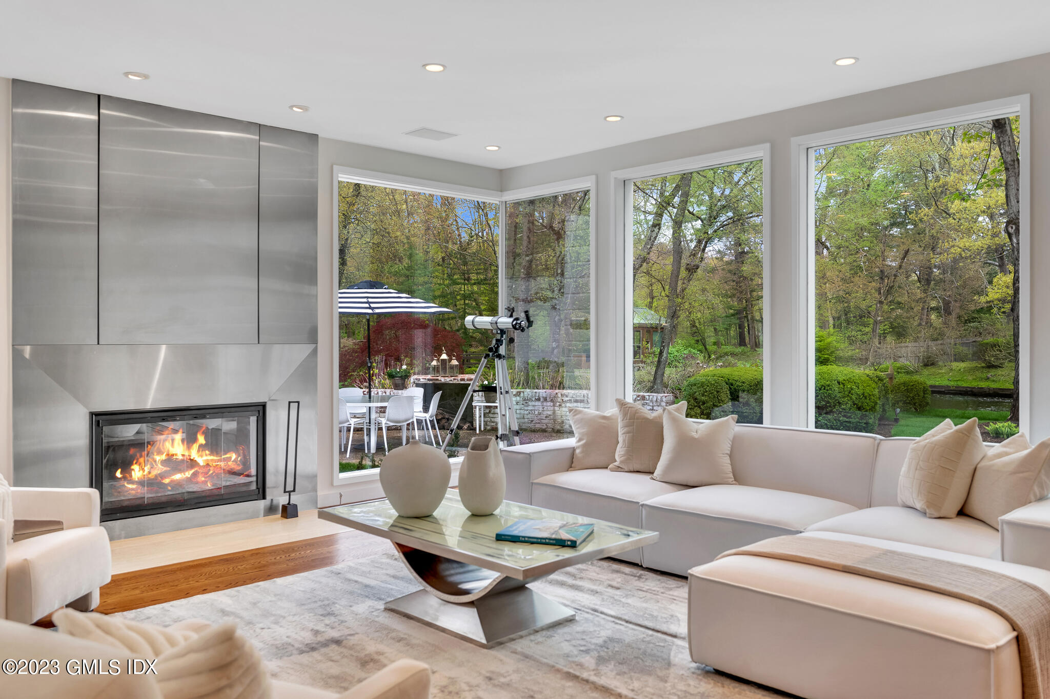 294 Riversville Road Greenwich, CT 06831 - Photo 6 of 17 a living room with furniture a fireplace and a floor to ceiling window