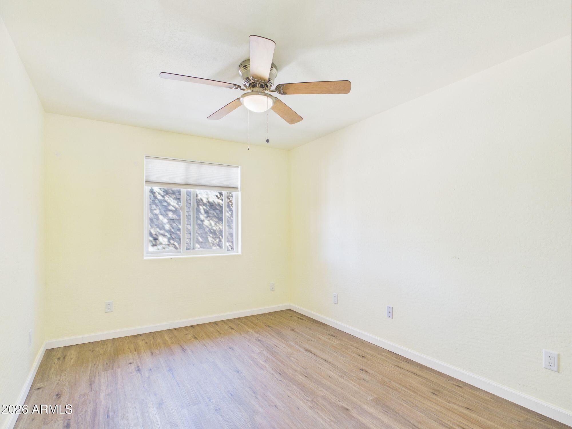 8071 Vista Del Norte Payson, AZ 85541 - Photo 11 of 27 an empty room with wooden floor fan and windows