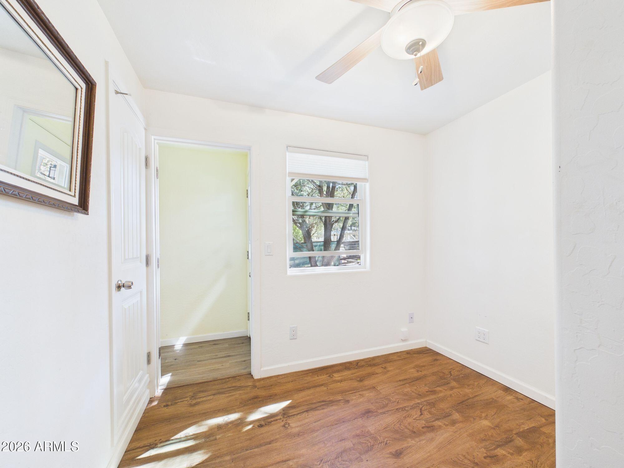 8071 Vista Del Norte Payson, AZ 85541 - Photo 13 of 27 a view of an empty room with wooden floor and a window