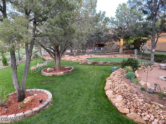 8071 Vista Del Norte Payson, AZ 85541 - Photo 22 of 27 a backyard of a house with a garden and outdoor seating