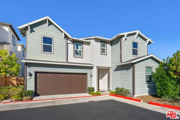 a front view of a house with a garage