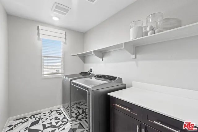 a utility room with sink dryer and washer
