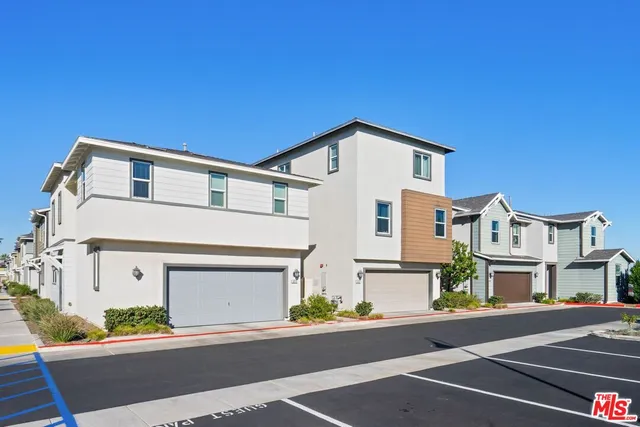 a front view of a house with a road