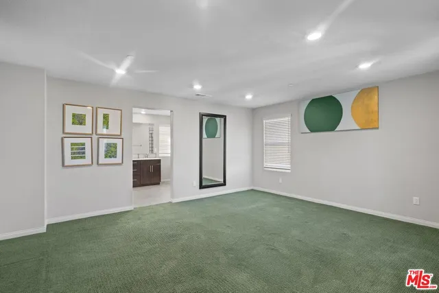 a view of an empty room with window and closet