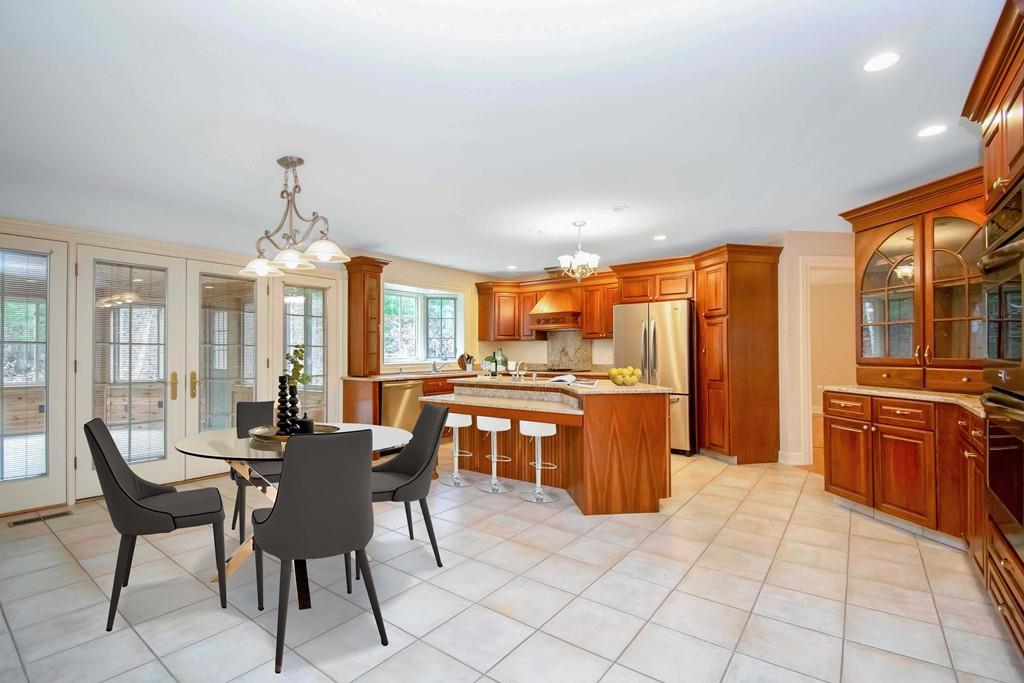 115 Chilson Road Wilbraham, MA 01095 - Photo 3 of 35 a dining hall with stainless steel appliances kitchen island granite countertop a stove a sink a dining table and chairs