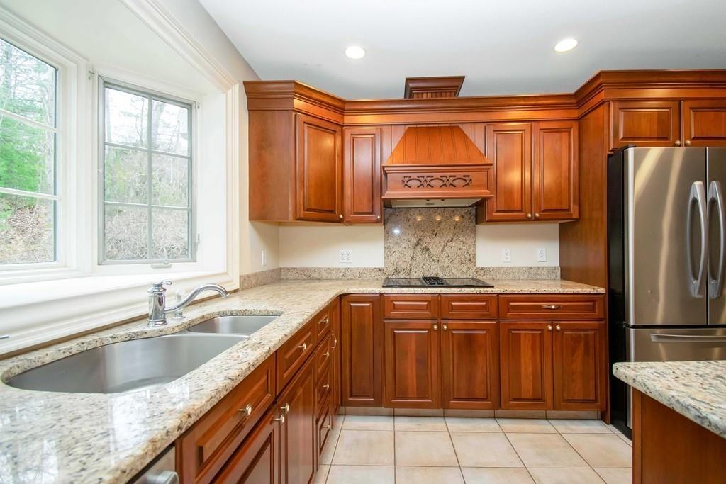 115 Chilson Road Wilbraham, MA 01095 - Photo 8 of 35 a kitchen with stainless steel appliances granite countertop a sink stove and refrigerator