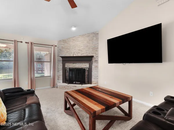 a living room with furniture and a flat screen tv