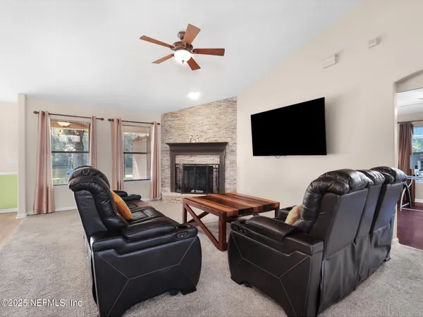a living room with furniture and a flat screen tv