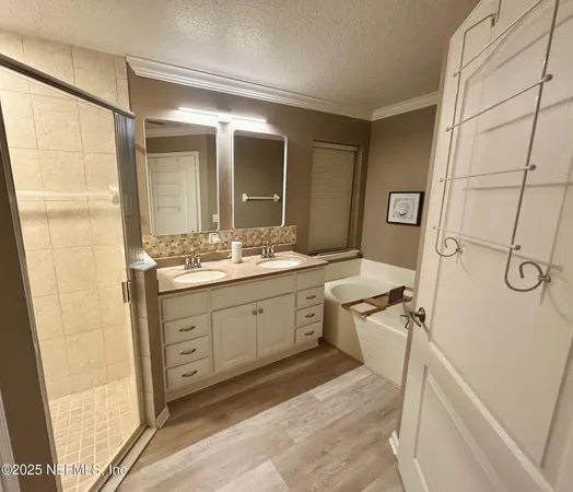 a spacious bathroom with a double vanity sink a mirror and a shower