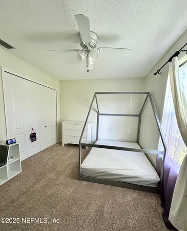 a view of a livingroom with furniture and a ceiling fan