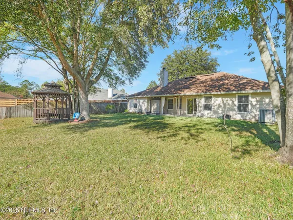 a view of a house with pool and a big yard