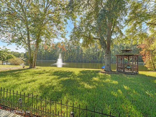 a view of a house with swimming pool and a yard