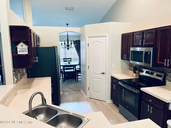a kitchen with a refrigerator and a sink