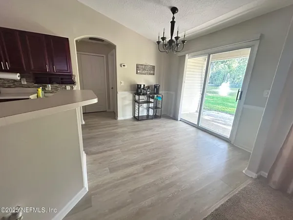 a open kitchen with window and wooden floor
