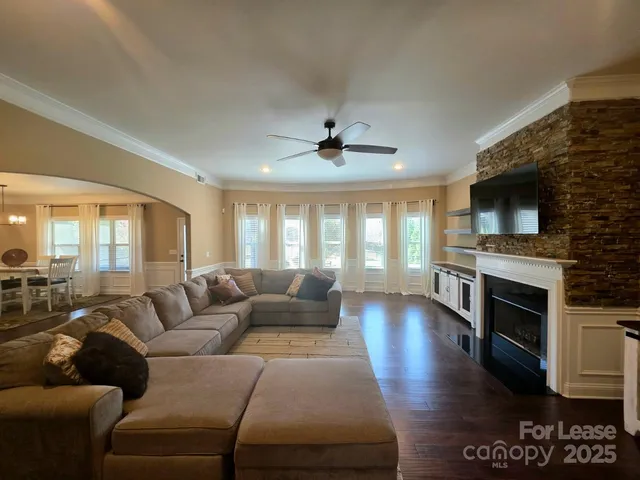 a living room with furniture fireplace and flat screen tv