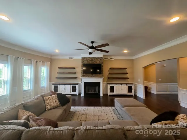 a living room with furniture and fireplace