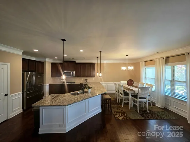 a large kitchen with a table and chairs