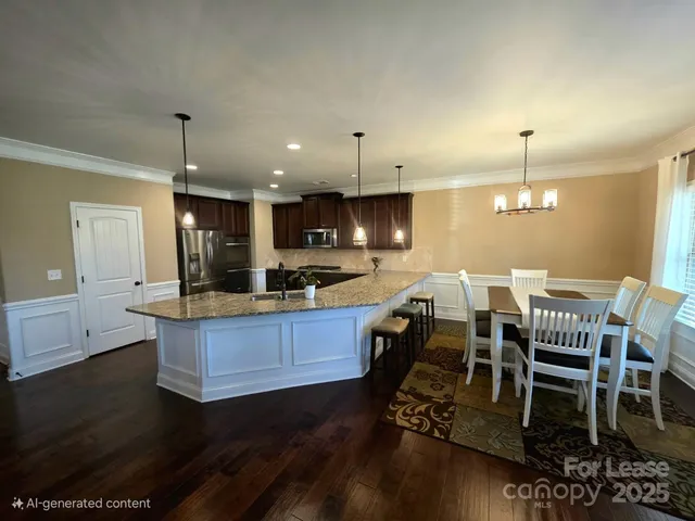 a kitchen with a dining table chairs and white cabinets