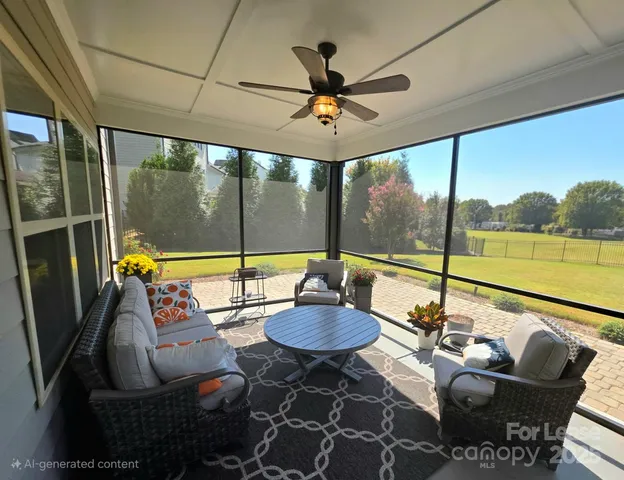a living room with furniture and a floor to ceiling window