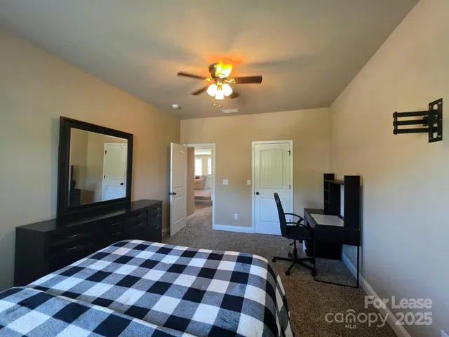 a bathroom with a granite countertop sink a shower and a mirror