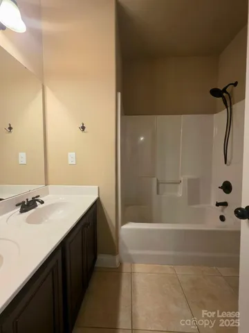 a white toilet sitting next to a bathroom sink and a shower
