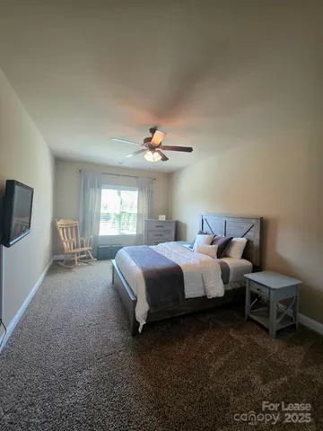 a spacious bedroom with a bed and window