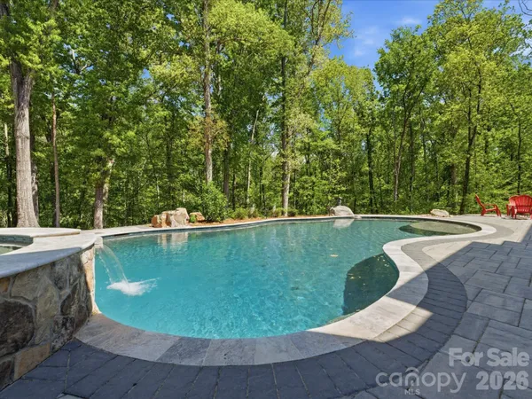 a view of a swimming pool with a yard